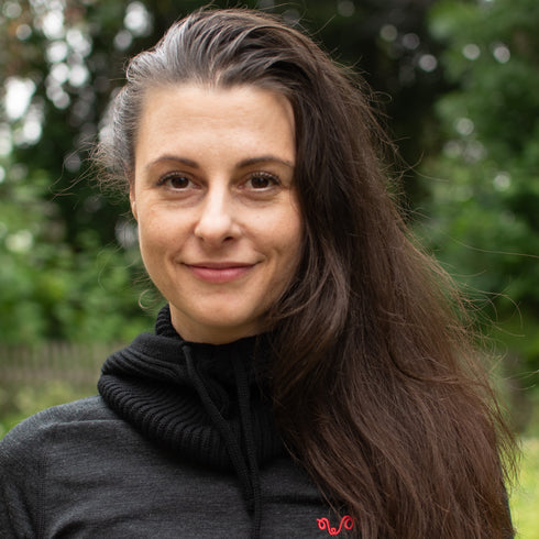 Die Dame trägt einen schwarzen Kapuzenschal um den Hals.